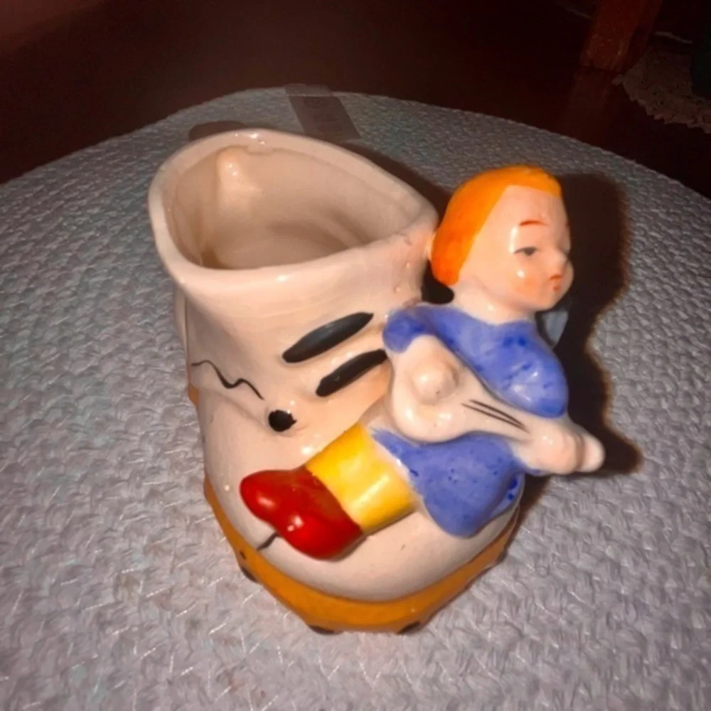 Vintage ceramic shoe with angel figurine planter
